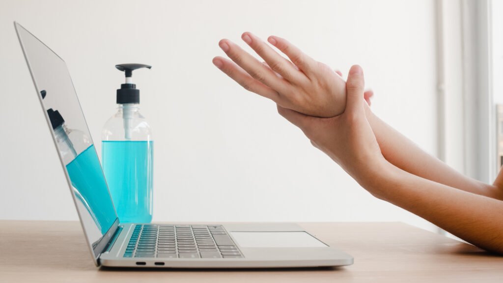 asian woman using alcohol gel sanitizer wash hand before work on